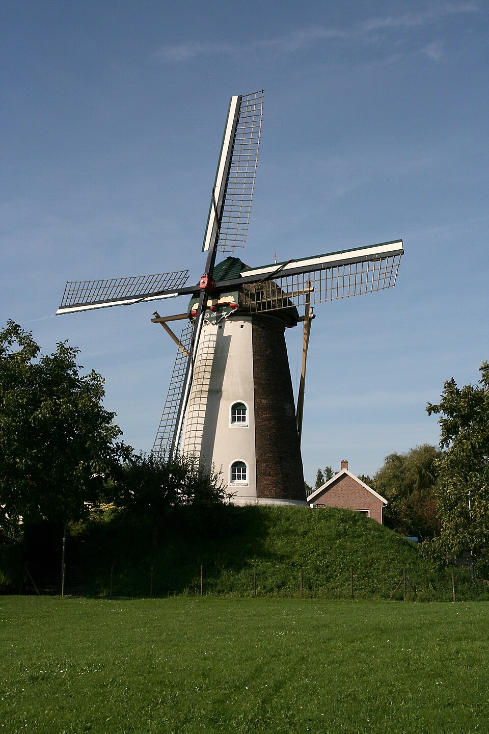 The brick tower and sails of De Bouwing windmill in Geldermalsen